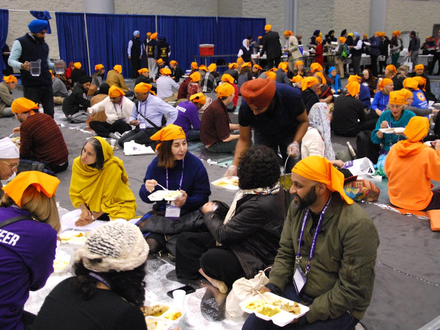 Attendees at the Parliament of the World's Religions conference enjoy a simple langar lunch prepared by Toronto's Sikh community. (Photo: Will Pearson)