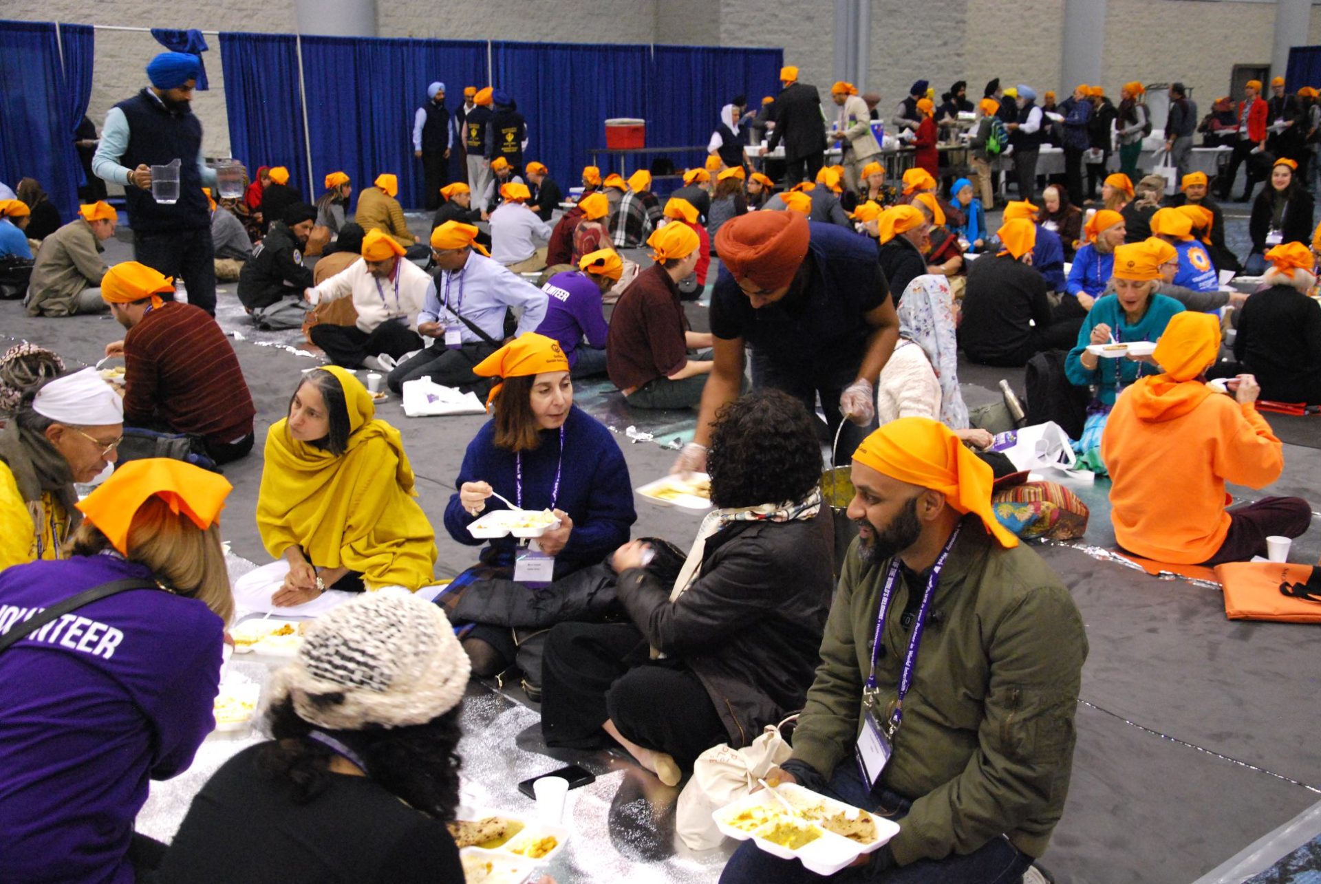 Attendees at the Parliament of the World's Religions conference enjoy a simple langar lunch prepared by Toronto's Sikh community. (Photo: Will Pearson)
