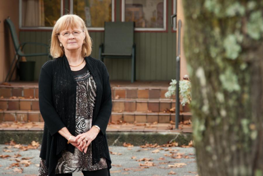 Bernadette stands in front of the former Burnaby Home for Girls, which is now a L'Arche community for people with developmental disabilities. Photo by Marlis Funk