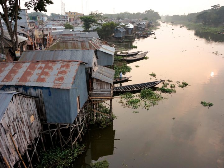 Riverside houses in Kotalipara, Bangladesh, are built on stilts to keep them out of reach of monsoon flooding. Photo by Josiah Neufeld