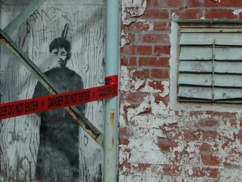 An image of a black-robed boy stares out from the wall of the now-demolished St. Michael’s Indian Residential School in Alert Bay, B.C. Photo by Pieta Woolley