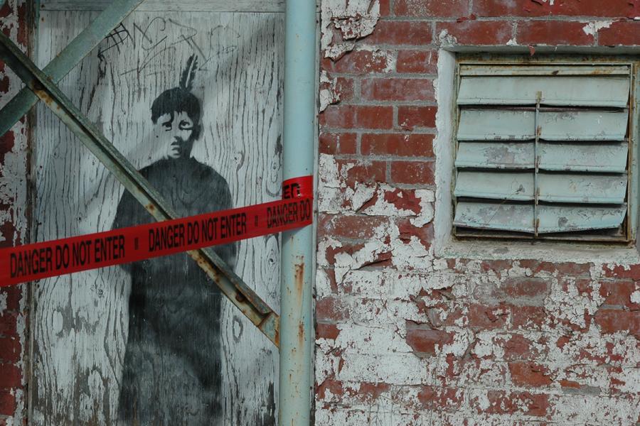 An image of a black-robed boy stares out from the wall of the now-demolished St. Michael’s Indian Residential School in Alert Bay, B.C. Photo by Pieta Woolley