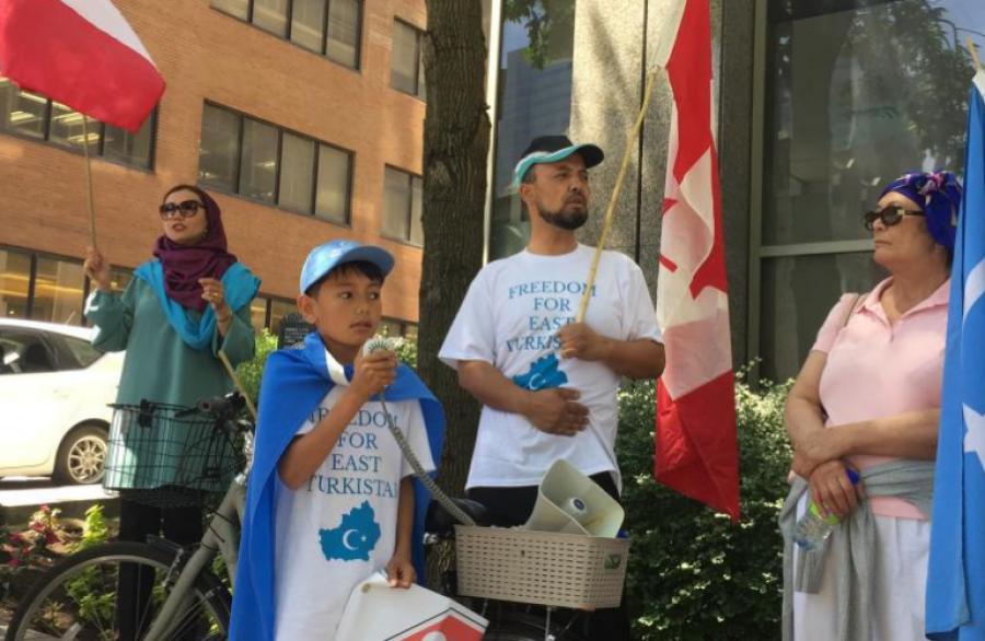 Bakhtiar (right) and his 11-year-old son protesting in Montreal.