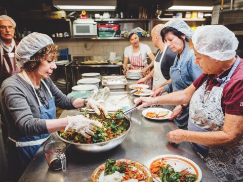 Second chance: Volunteers prepare a meal at the Church of the Redeemer in Toronto’s Yorkville neighbourhood. The menu is improvised, based on the surprise delivery from Second Harvest. (Photo: Bill Leontaritis)