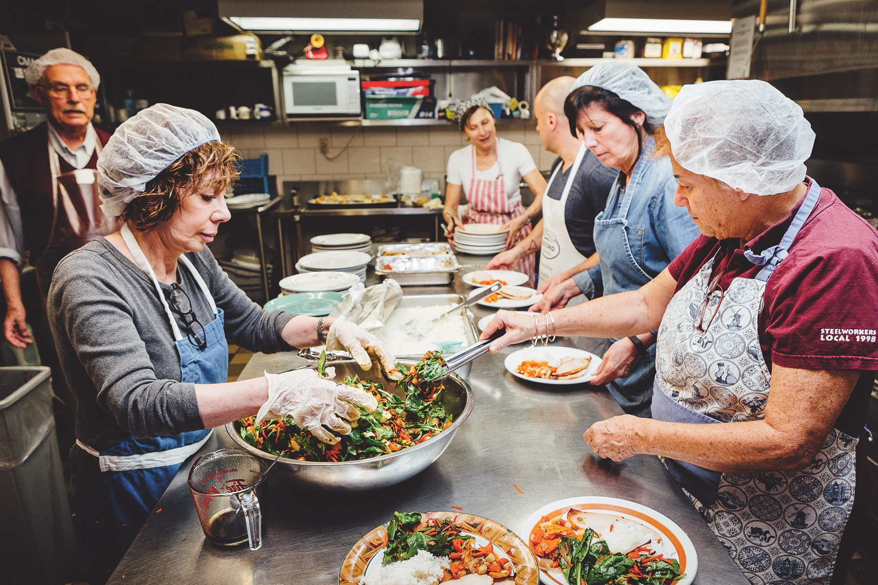 Second chance: Volunteers prepare a meal at the Church of the Redeemer in Toronto’s Yorkville neighbourhood. The menu is improvised, based on the surprise delivery from Second Harvest. (Photo: Bill Leontaritis)