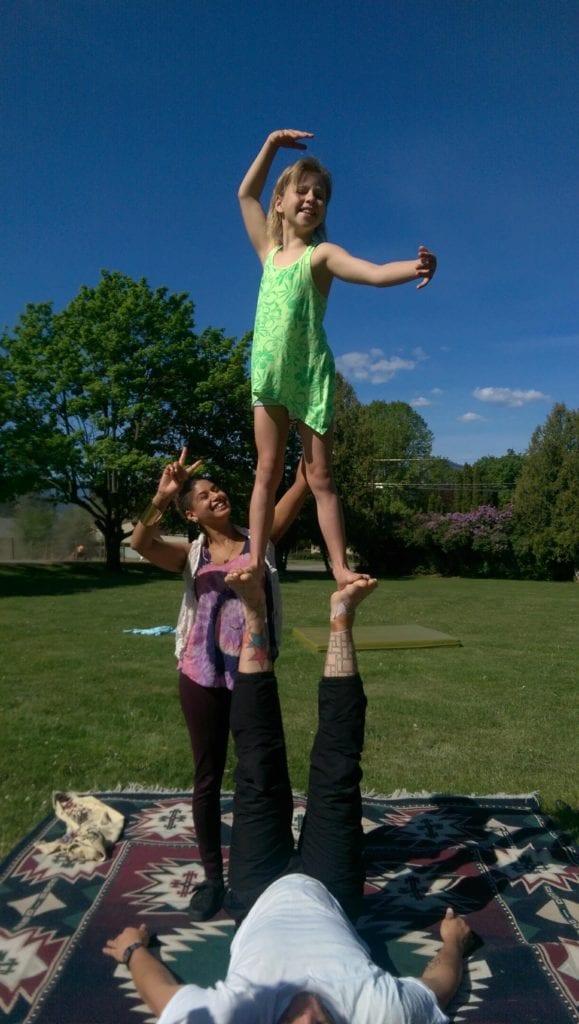 Girl standing on an adult's feet in Naramata, B.C. 