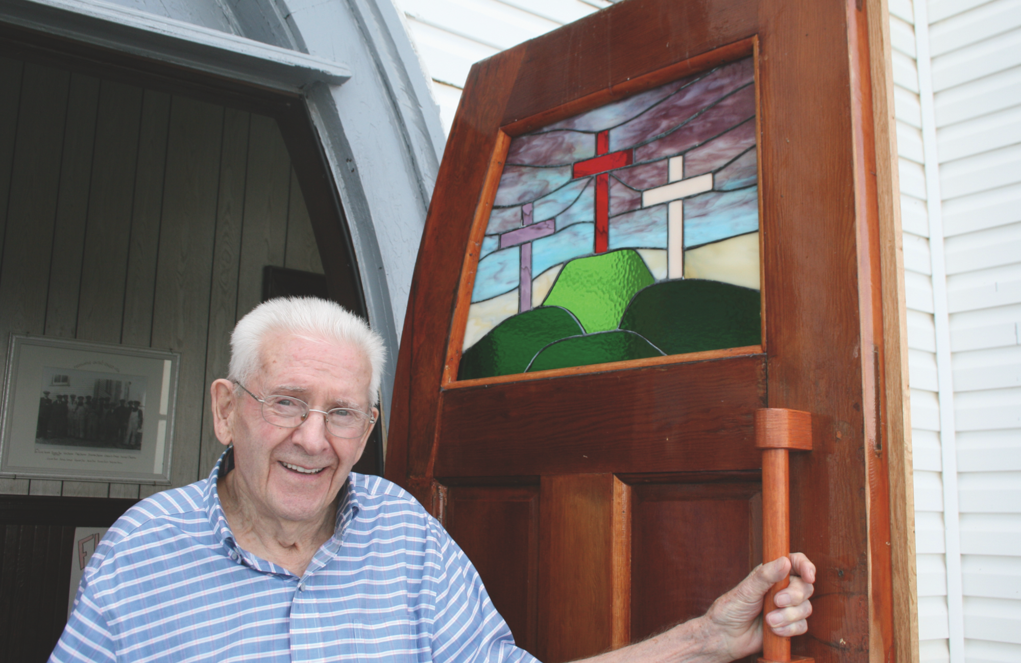 Eric Parsons by the doors of Freshwater (N.L.) United, which he had recently refinished, in July 2019. (Photo: Denise Flint)