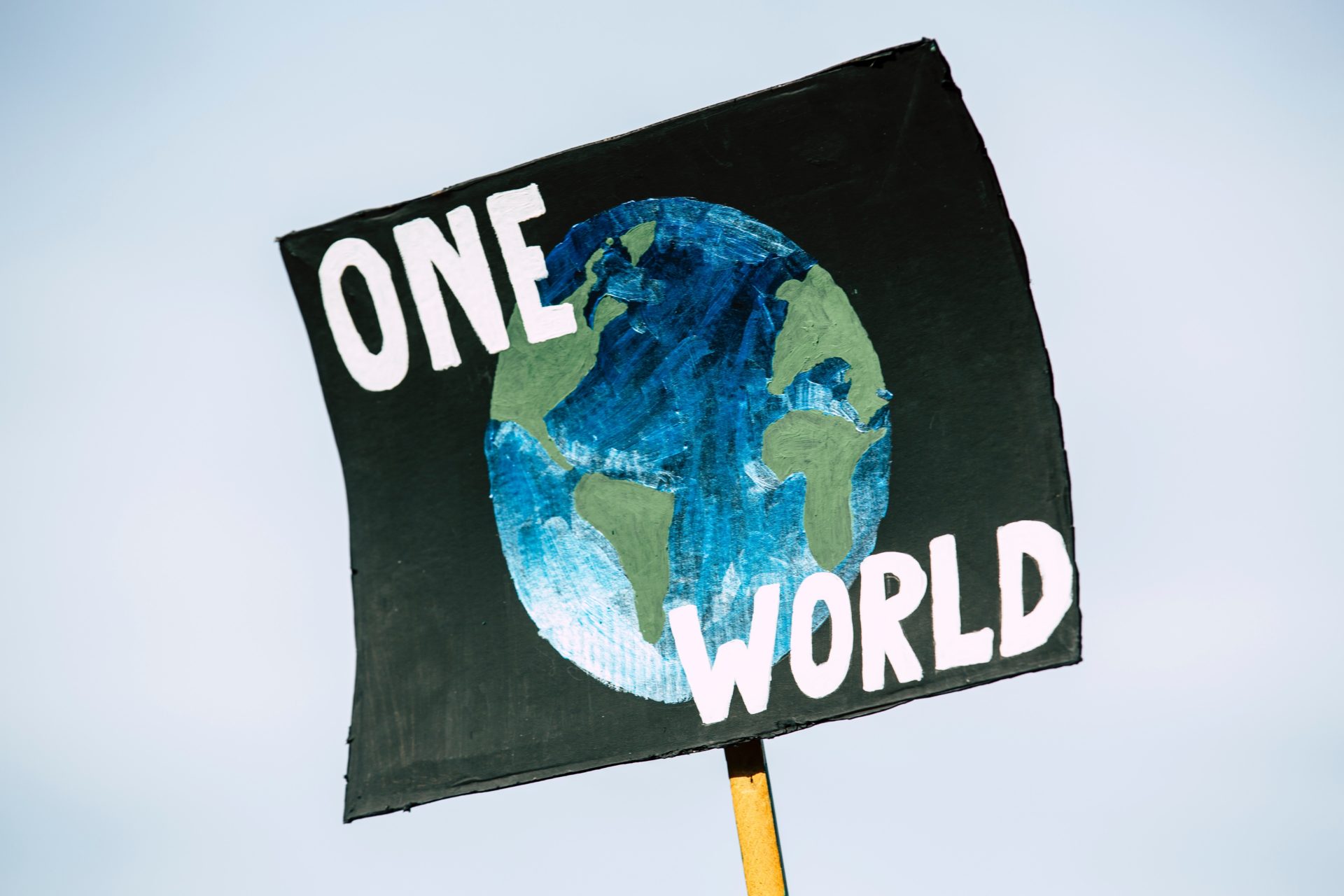 A person at a climate crisis protest holds a sign. (Stock photo: Markus Spiske on Unsplash)