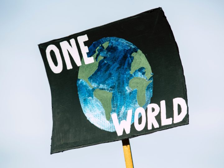 A person at a climate crisis protest holds a sign. (Stock photo: Markus Spiske on Unsplash)
