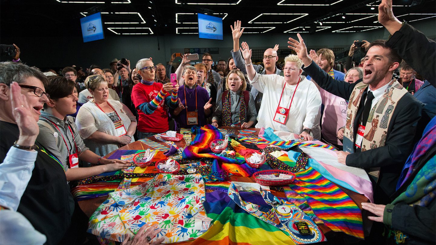 Supporters of LGBTQ rights in The United Methodist Church rally around the central Communion table at the close of the 2016 United Methodist General Conference in Portland, Ore. (Photo: Mike DuBose, courtesy of UMNS)