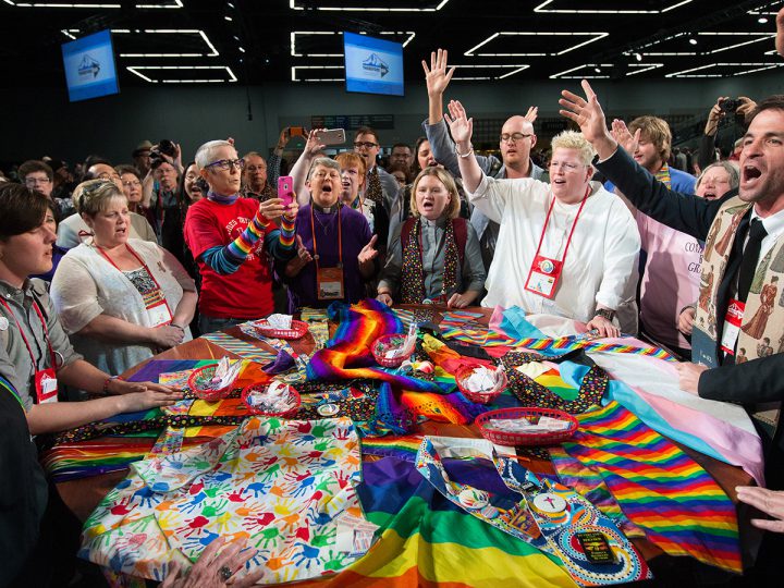 Supporters of LGBTQ rights in The United Methodist Church rally around the central Communion table at the close of the 2016 United Methodist General Conference in Portland, Ore. (Photo: Mike DuBose, courtesy of UMNS)