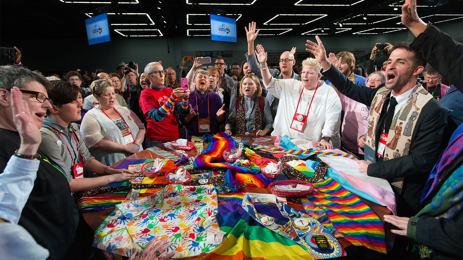 Supporters of LGBTQ rights in The United Methodist Church rally around the central Communion table at the close of the 2016 United Methodist General Conference in Portland, Ore. (Photo: Mike DuBose, courtesy of UMNS)