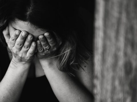 a woman with her head in her hands