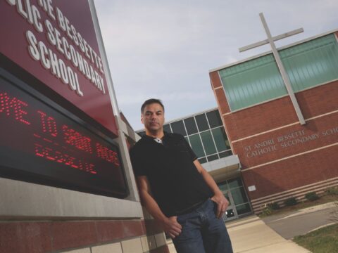 Father stands in front of school