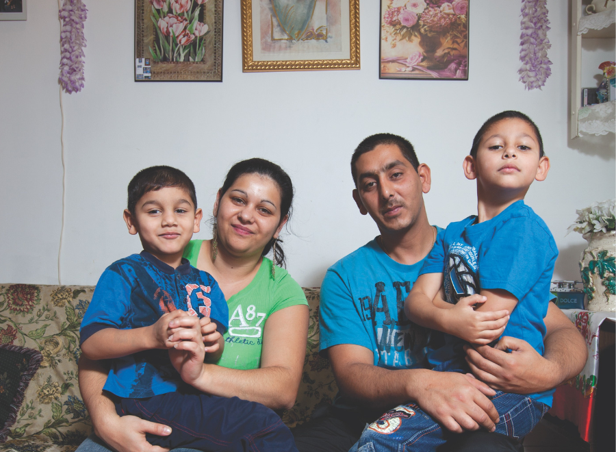 Roma family of four on couch