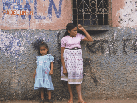 woman and child in front of wall el salvador