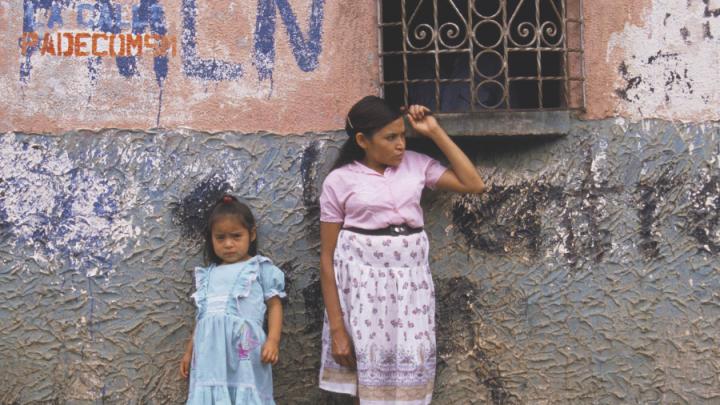 woman and child in front of wall el salvador