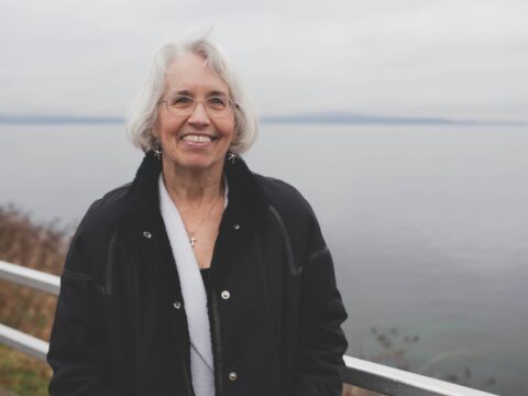 White-haired woman on shore