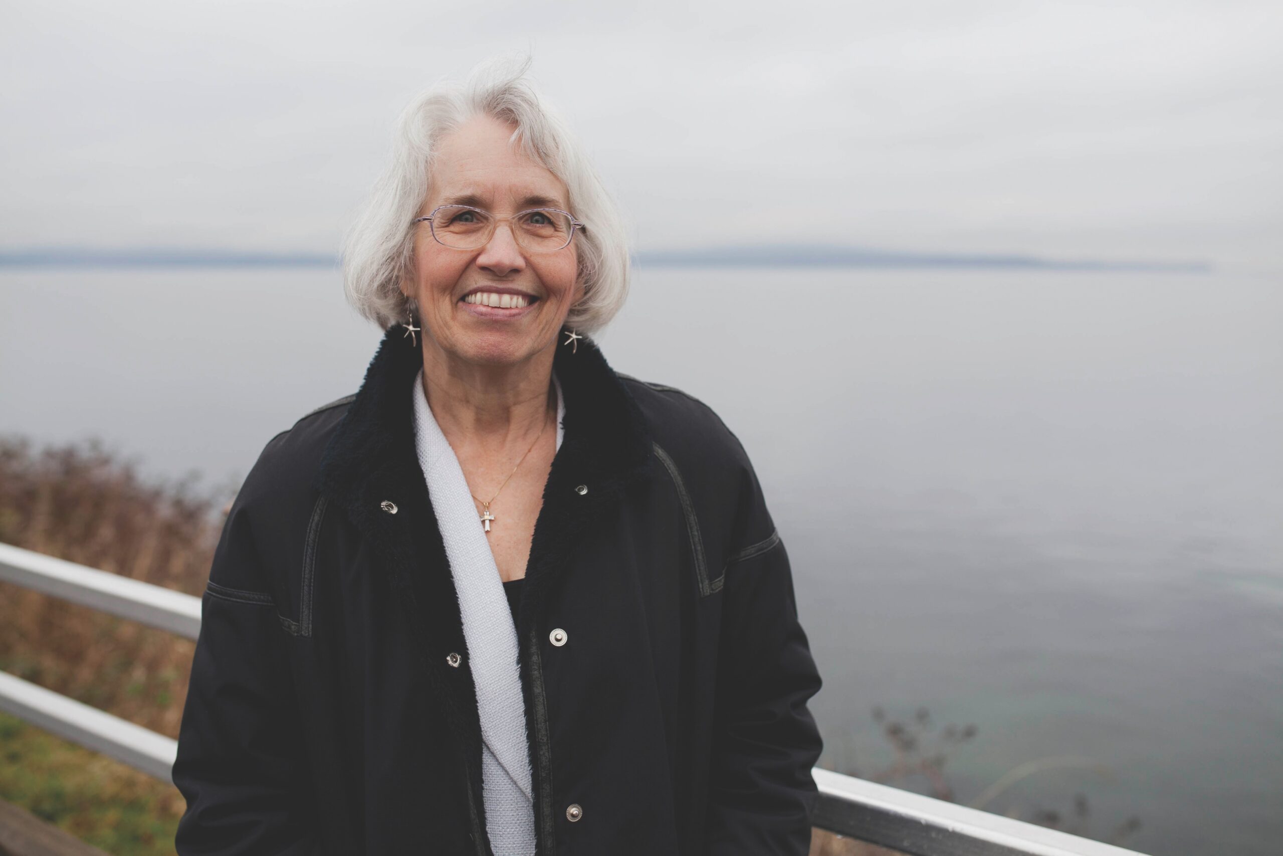 White-haired woman on shore