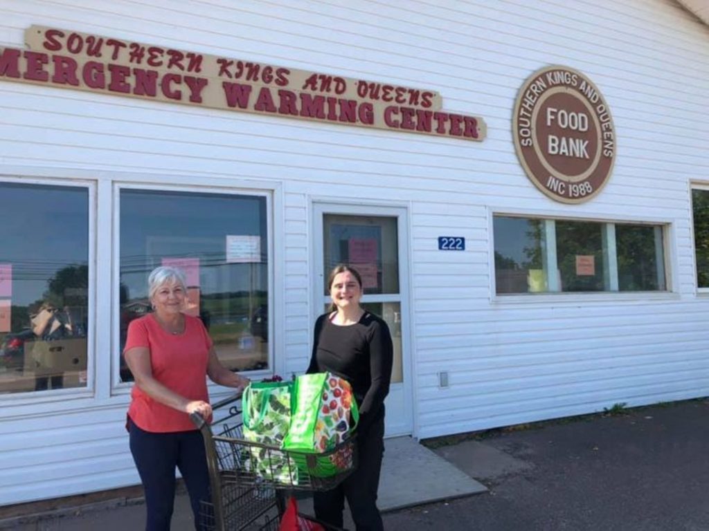 two people stand in front of the Southern Kings and Queens Food Bank in Montague, Prince Edward Island