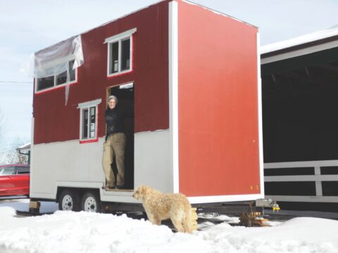 woman standing with tiny home