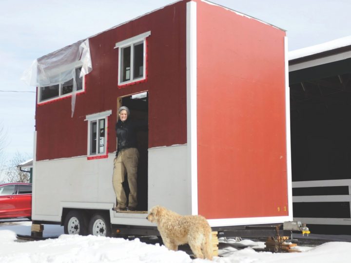 woman standing with tiny home