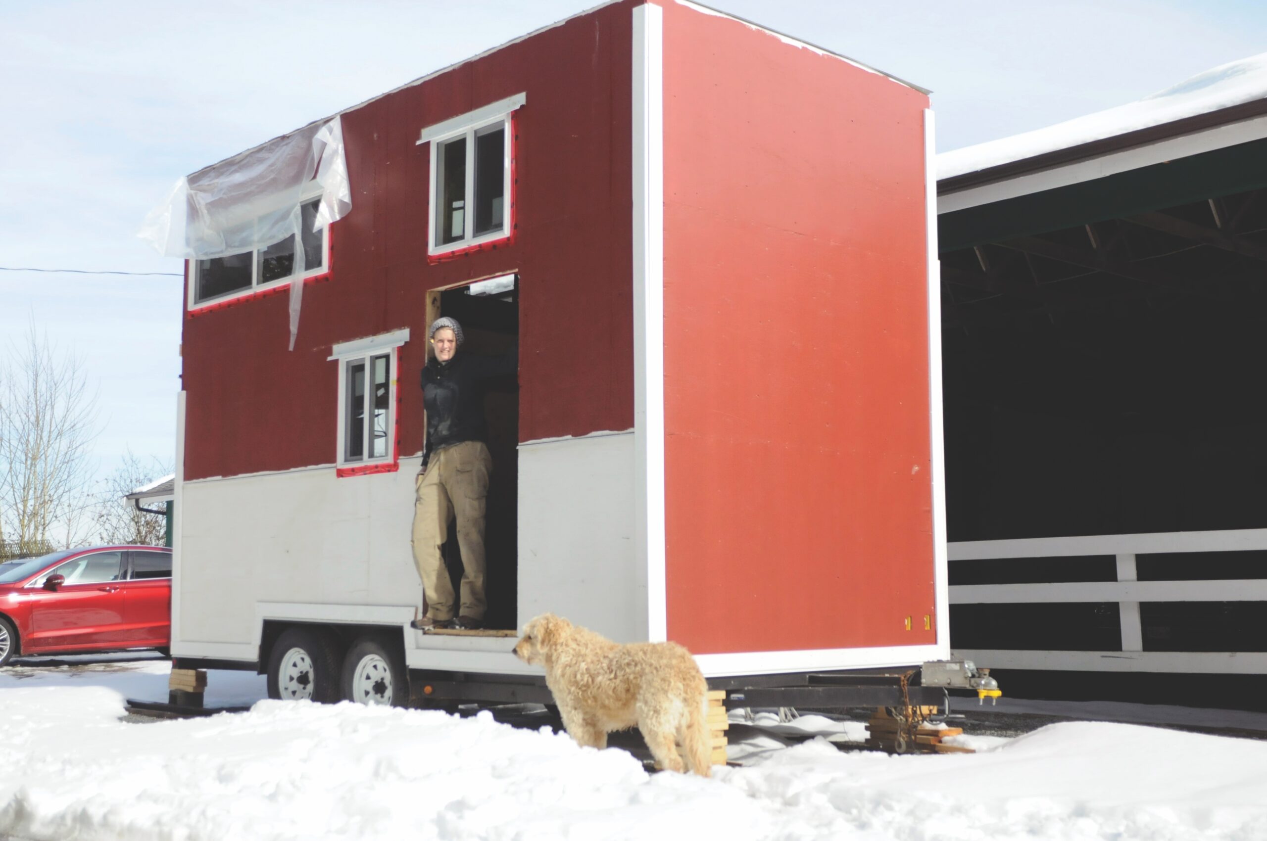 woman standing with tiny home