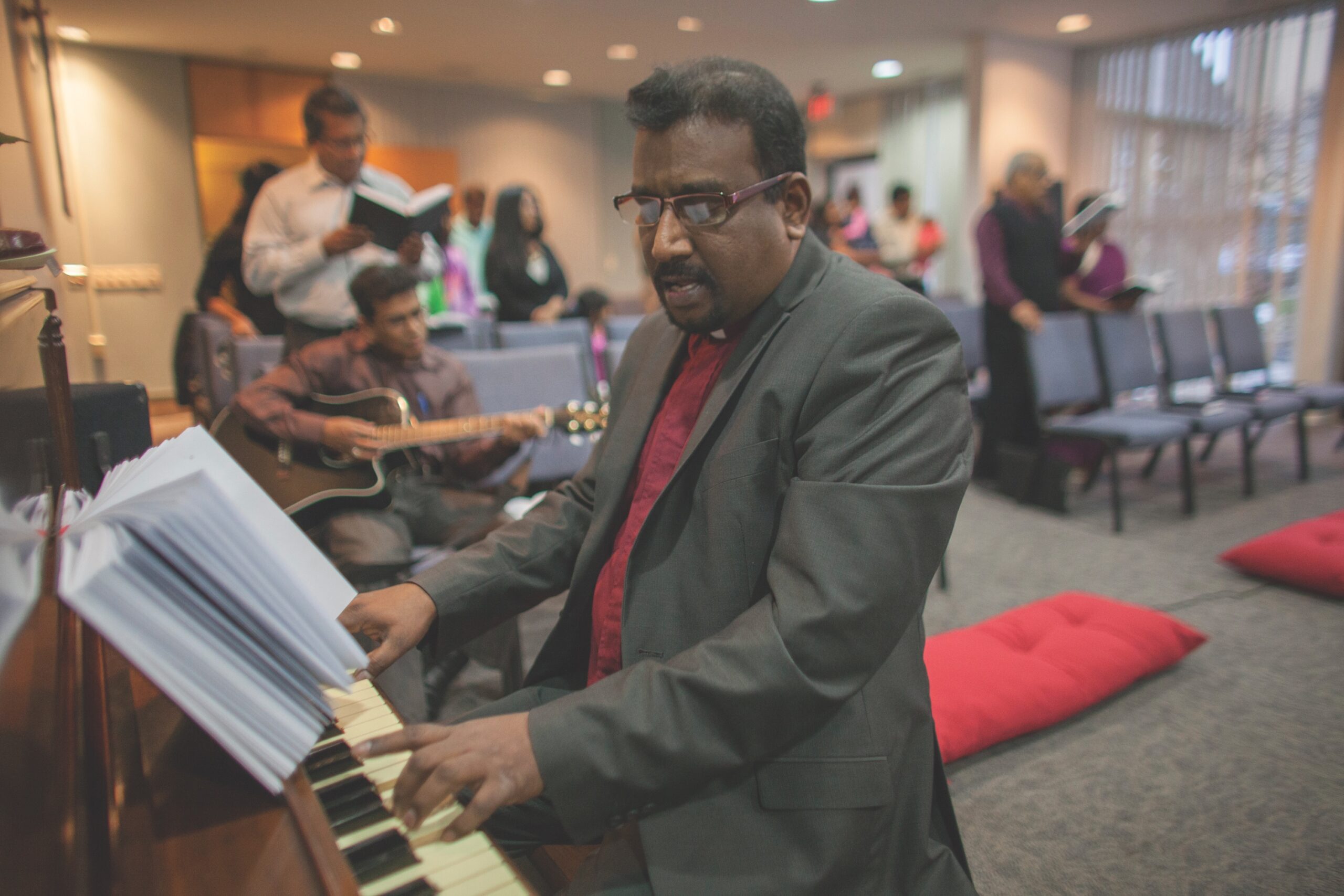 Standing man plays piano