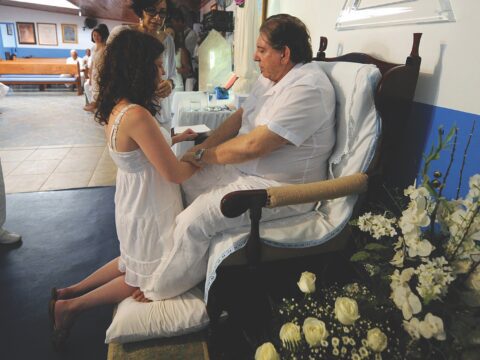 man seated, woman kneeling