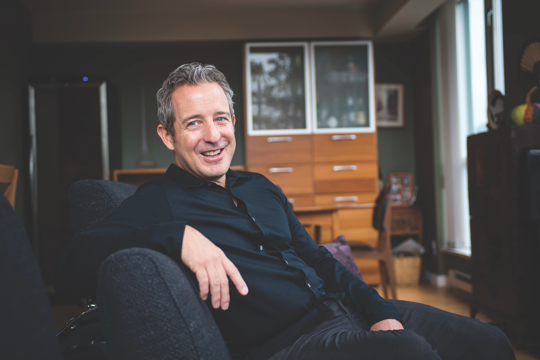 man reclined on couch looking at camera