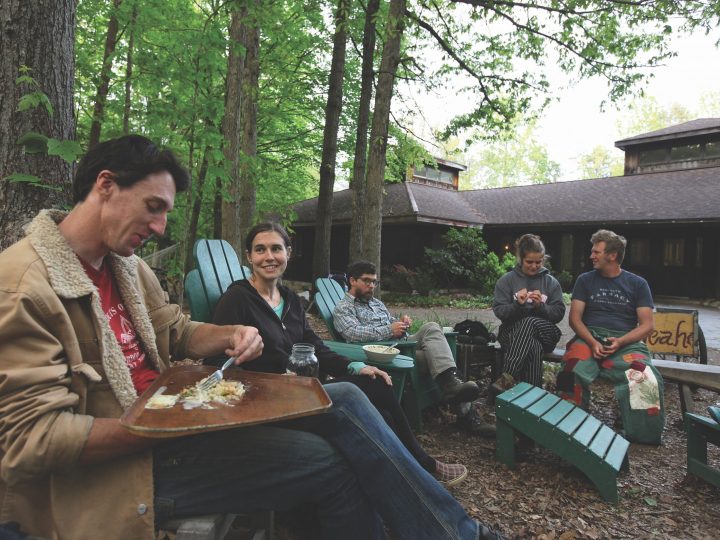 group of people sitting in woods