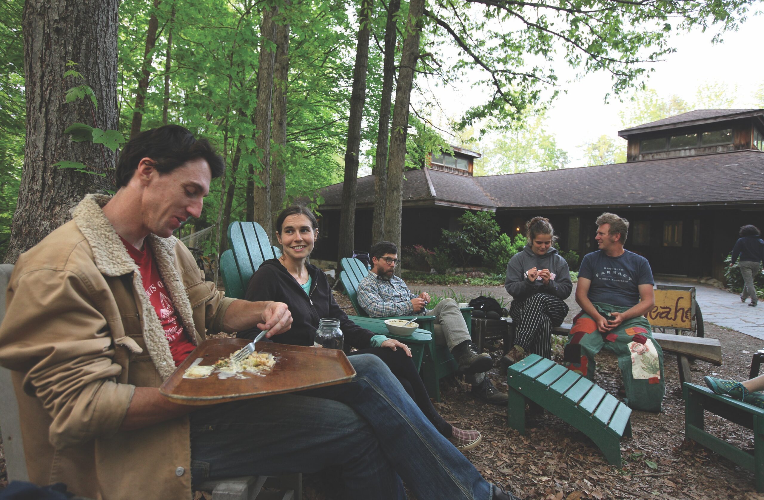 group of people sitting in woods