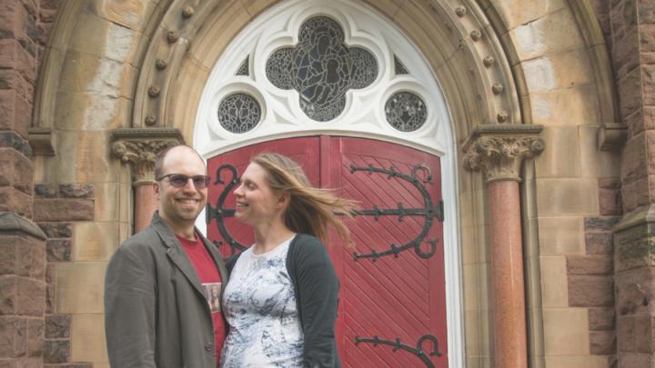 young couple in front of church entry