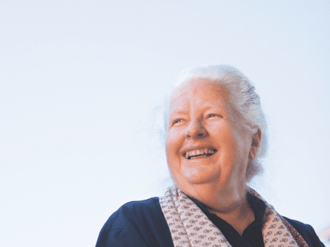 white woman with white hair and scarf