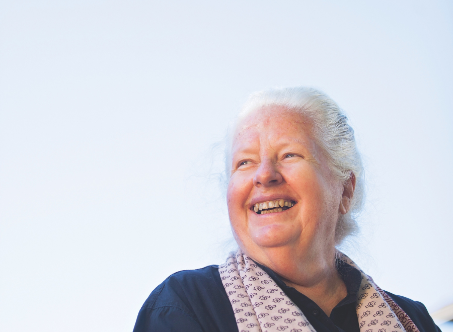 white woman with white hair and scarf