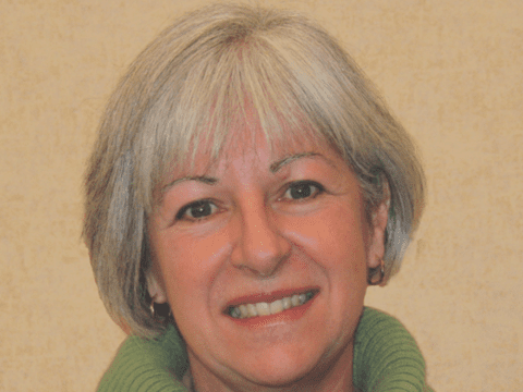 White woman looks into camera