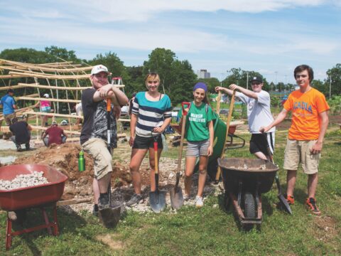 Young people with shovels and wheelbarrows