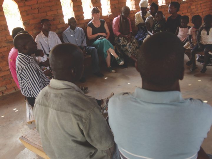 Malawians sit in circle in church
