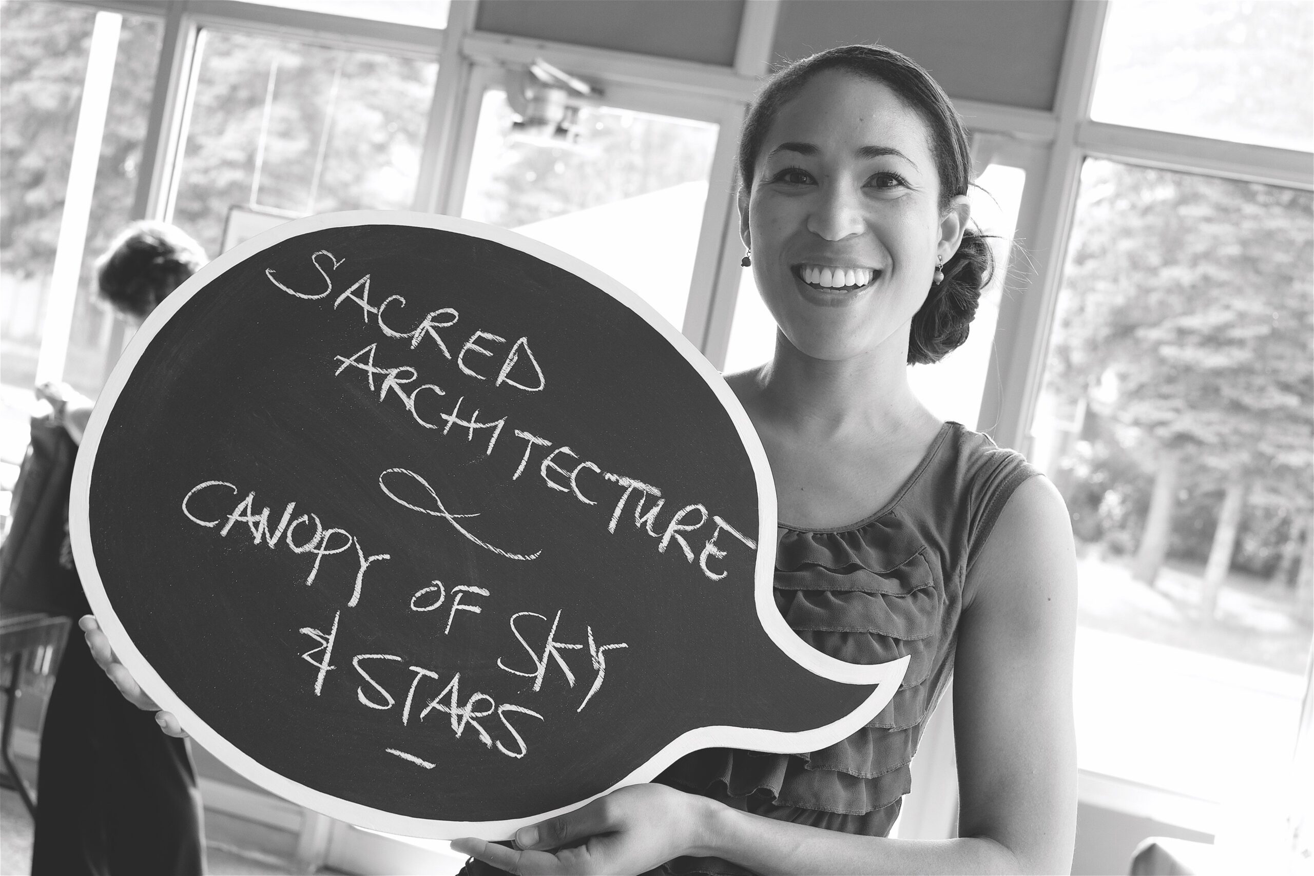 Woman holds blackboard speech bubble