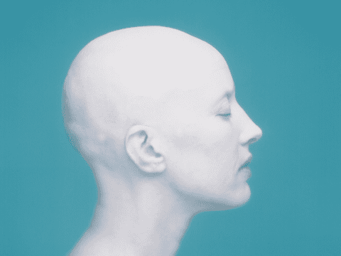 hairless white woman in profile against blue