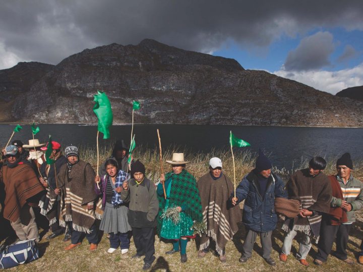 Peru villages protest in front of lake and mountain