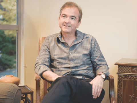 white man sitting in chair