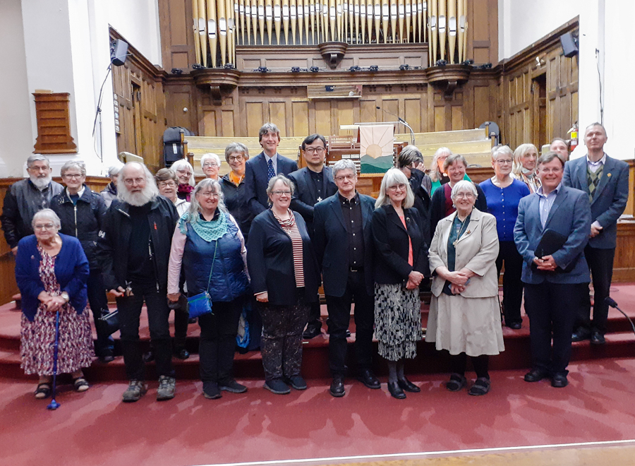 A large group of people having their photo taken in a church.