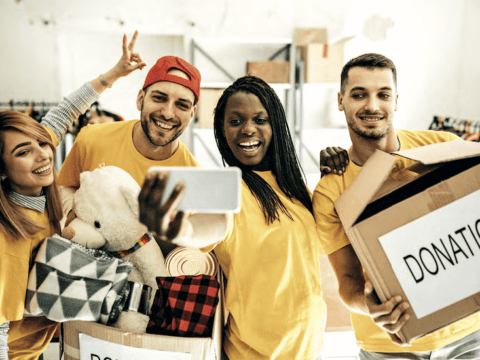 friends in yellow t-shirts holding donations