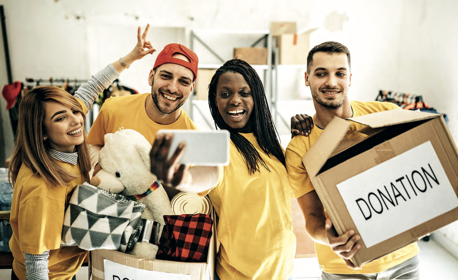 friends in yellow t-shirts holding donations