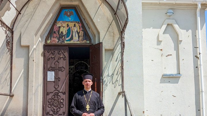 Father Vasyl standing outside his church