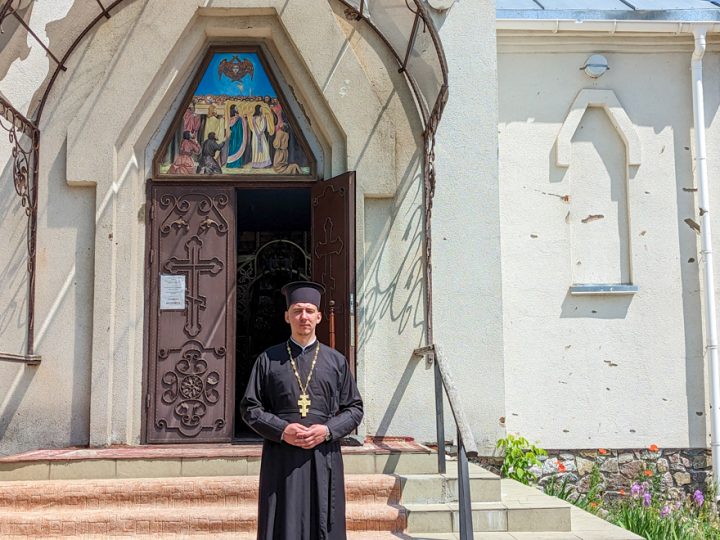 Father Vasyl standing outside his church