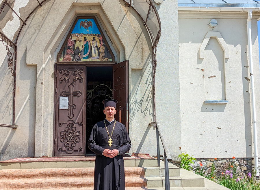 Father Vasyl standing outside his church