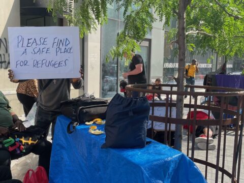 Toronto resident holding a sign in protest