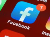 Closeup of phone screen showing Facebook and Instagram logos